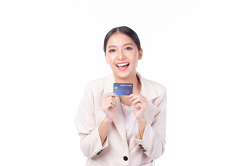 Portrait of a happy young asian woman wearing suit holding bank card, credit card isolated on white...