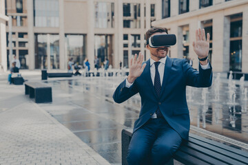 Young business owner in blue formal suit reviewing projects in virtual reality