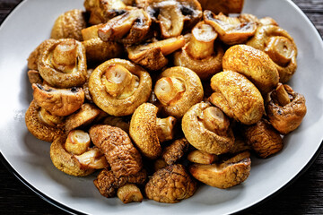 grilled juicy mushrooms on a plate, top view