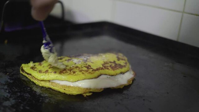 Preparation of a Traditional Venezuelan Dish, Sweet Corn Crepe Cachapa Filled with Cheese