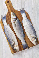 Raw sea bass on a table, top view, close-up