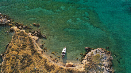 Aerial drone top down photo of small tropical exotic island covered in  limestone with emerald sea
