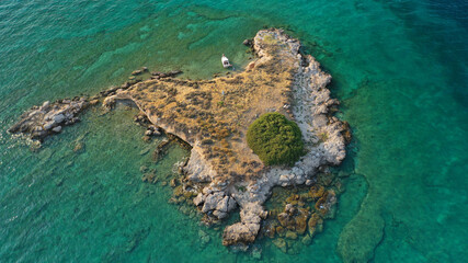 Aerial drone top down photo of small tropical exotic island covered in  limestone with emerald sea