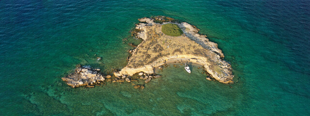 Fototapeta na wymiar Aerial drone top down photo of small tropical exotic island covered in limestone with emerald sea