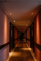 Hotel - Illuminated corridor of hotel rooms