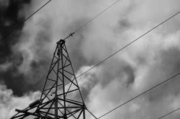 black and white photo of power lines in clouds