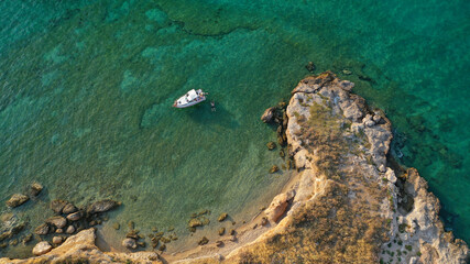 Aerial drone photo of power boat anchored in tropical Caribbean turquoise bay with calm sea