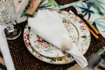 wedding decoration - table set with plates, cutlery and glasses