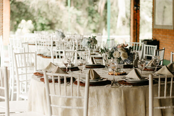 wedding decoration - table set with plates, cutlery and glasses