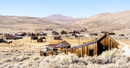 Ghost town of Bodie in California - Travel destination concept with wide angle view of abandoned...