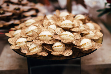 Sweets for wedding - white chocolate bonbon in the shape of a seashell