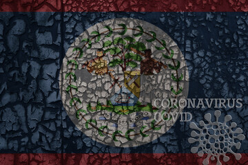 Obraz na płótnie Canvas flag of belize on a old metal rusty cracked wall with text coronavirus, covid, and virus picture.