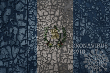 flag of guatemala on a old metal rusty cracked wall with text coronavirus, covid, and virus picture.
