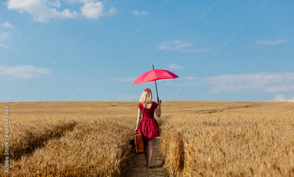 Canvas Prints blonde girl in red dress with umbrella and suitcase on wheat field