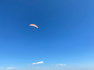 Young man paragliding during summer off cliffs in Baja, Mexico