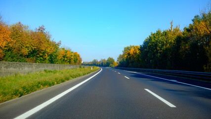 driving on a road through a forest in germany in october
