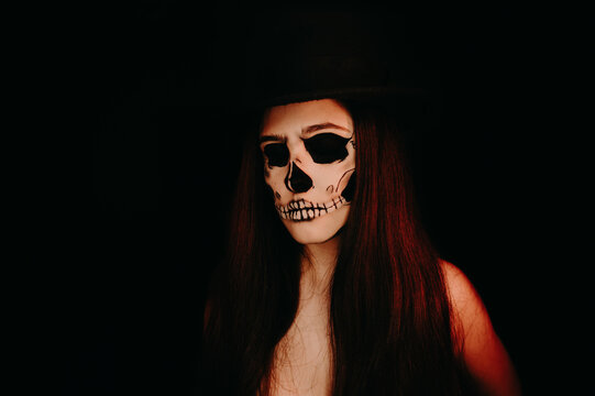 A girl with skull make up. Halloween happy party.