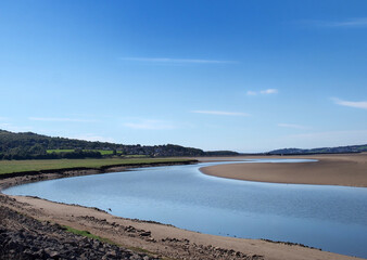 the river kent in cumbria with with the town of arnside in the distance