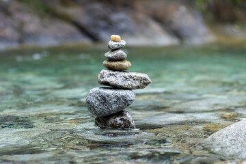 Fototapeta na wymiar Balanced stones forming a natural sculpture in a river or waterfall 