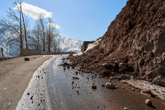 Early spring in the mountains. The rocks fell on the road. Dangerous bugle road. Rockfall in the mountains