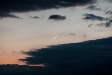 Moon between clouds