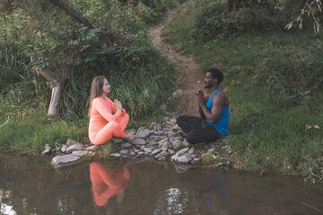 Couple have a meditation by the river