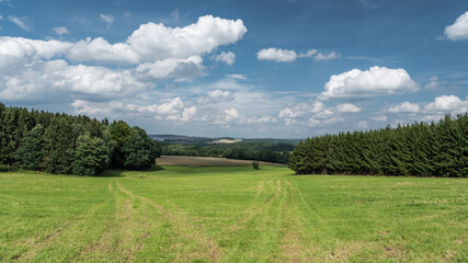 Obraz premium View over the hills and trees and agriculture land at the German countryside