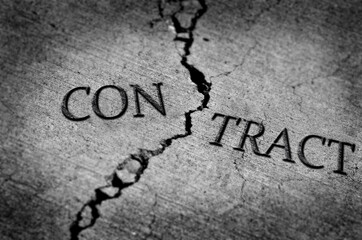 Fototapeta premium Broken or Breached Contract Symbolized by Cracked Cement Broke Ended