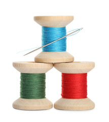Different colorful sewing threads with needle on white background