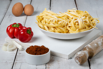Fresh noodles on white table, copy space