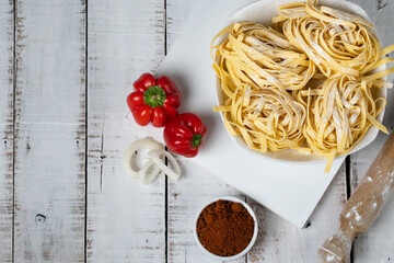 Fresh noodles on white table, copy space