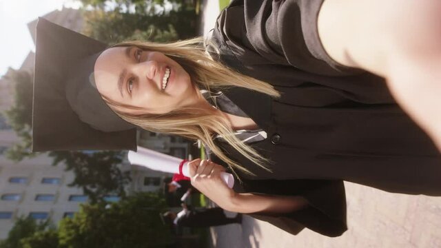 Outside of the college building in the garden charismatic lady make a selfie video for her parents after she was graduate. Shot on ARRI Alexa Mini.