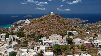 Aerial drone photo of main village of Plaka, main village of Milos island featuring uphill castle...