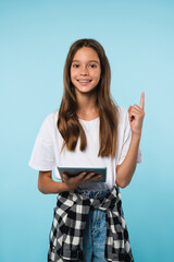 Smart caucasian schoolgirl teenager student pupil having an idea pointing at copy space using...