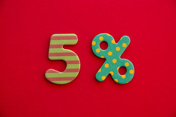 Number five and percent sign in funny pattern on a red color background. Discount, sale concept