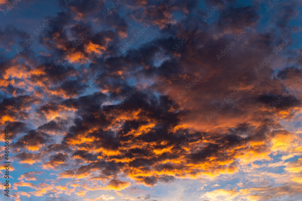 Wall mural the sky at dusk the rays of the sun hit the clouds, creating beautiful and frightening colors at the