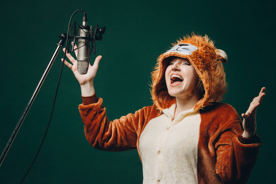 Woman prepares herself and a material before voice recording. Soundproof room for professional recording vocal. Voice artist works with material before dubbing or voice over process