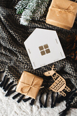 White toys house and gift box on black blanket