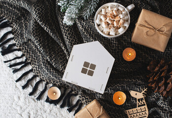 White toys house and gift box on black blanket