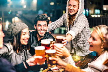 Happy people drinking beer at brewery bar out doors - Multicultural life style concept with genuine friends enjoying time together at open air restaurant patio - Vivid filter with focus on guy - obrazy, fototapety, plakaty