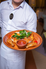 baked chicken with sauce and herbs on a tray