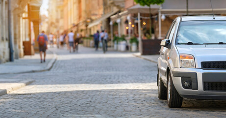 Close up of a car parked illegally against traffic rules on pedestrian city street side.