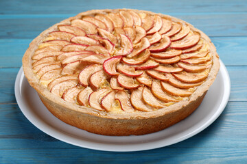 Tasty apple pie on light blue wooden table