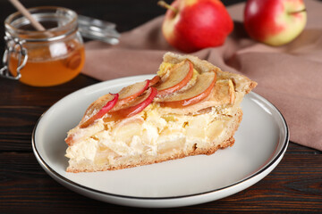 Piece of delicious homemade apple pie on wooden table