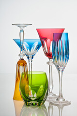 photographic arrangement of a set of different crystal glasses of different shapes, colors and uses
