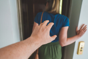 Stranger harasses the woman entering the elevator.
