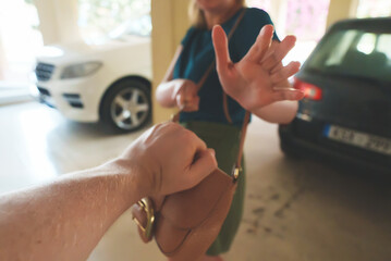 Thief snatches a bag from a woman in the parking lot.
