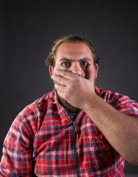 Man covering mouth with hand