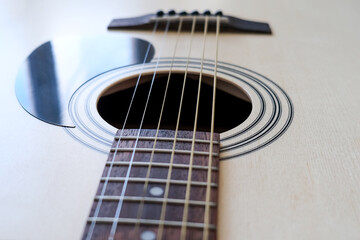 Details of classic acoustic guitar, strings and chords, guitar neck close up