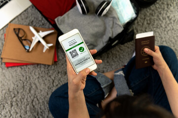 Health passport certification app, Tourist use smartphone to checking for certifying vaccinated...
